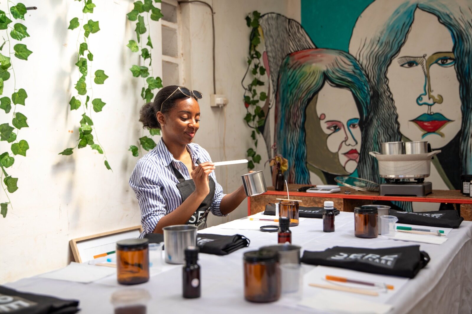 A guest stirring wax during a Sere candle-making workshop